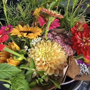 Paper-wrapped bouquets featuring dahlias, zinnias and sunflowers.